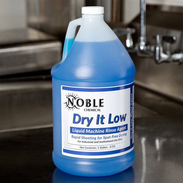 A white jug of Noble Chemical Dry It low rinse aid on a counter.