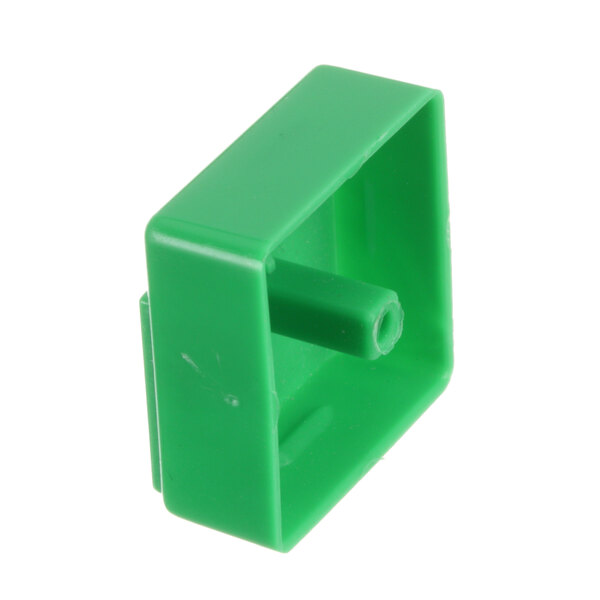 A green plastic square with a hole in it.