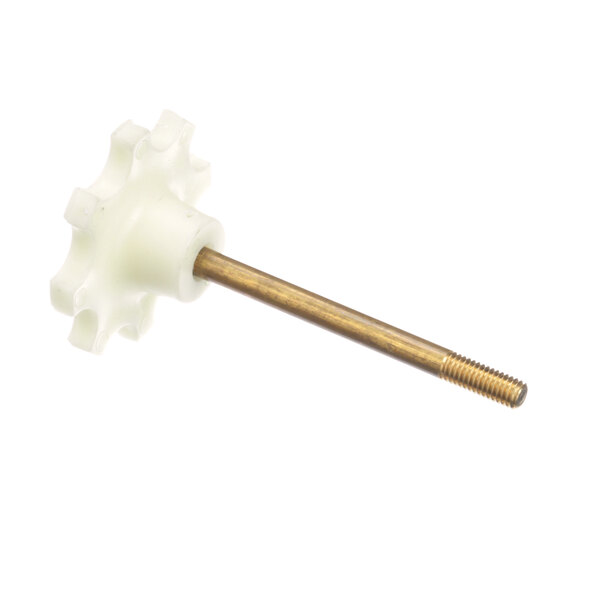 A white plastic gear with a gold metal rod.