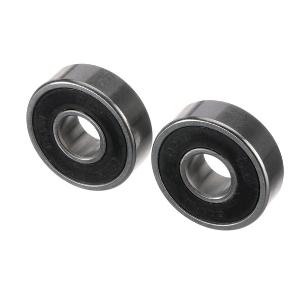 A pair of black rubber Electrolux Professional bearings on a white background.