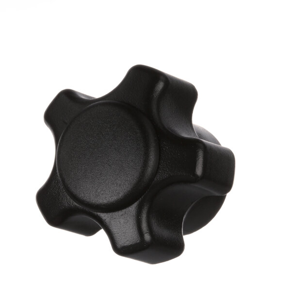 A close-up of a black plastic knob with a star shape.