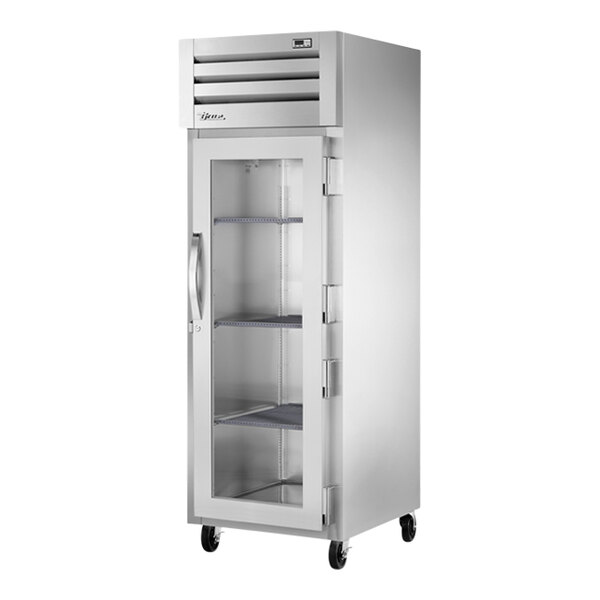 A True silver metal reach-in refrigerator with glass doors and shelves.