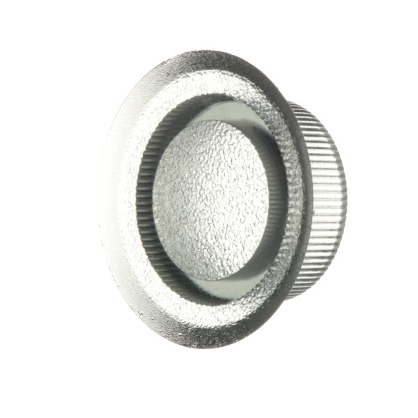 A close-up of a silver circular knob.
