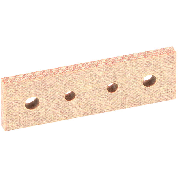 A close-up of a white Vulcan Isolator Block, a small piece of wood with holes in it.