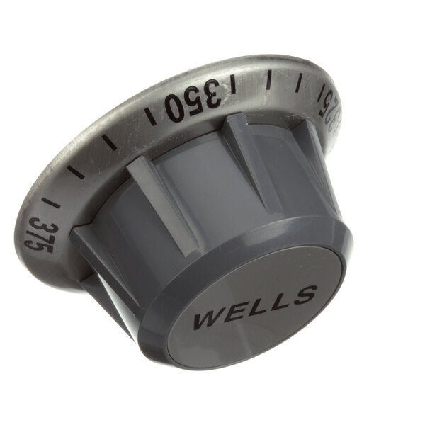 A gray plastic Wells knob with black numbers.