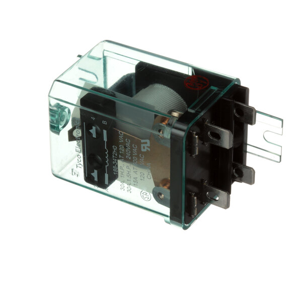 A clear plastic box with black metal parts including a green Mannhart Relay cover.