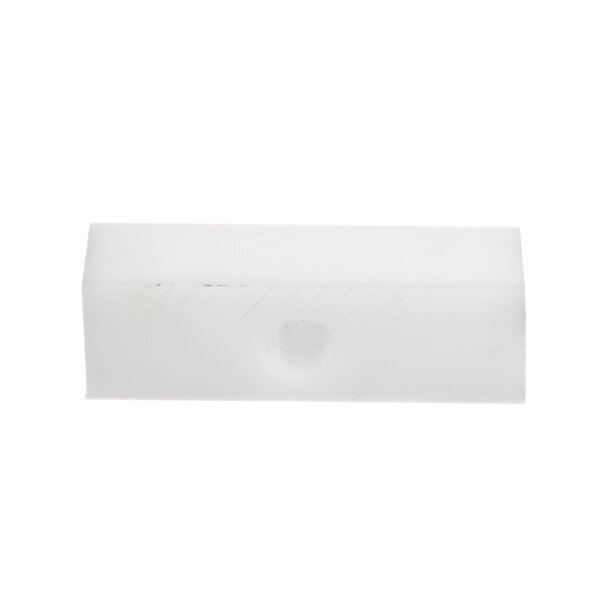 A white rectangular plastic block with a hole in it.