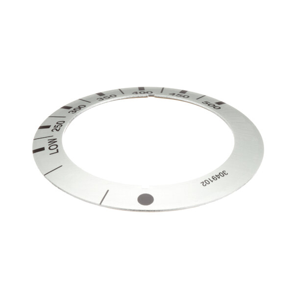 A white circular metal dial insert with numbers on it.