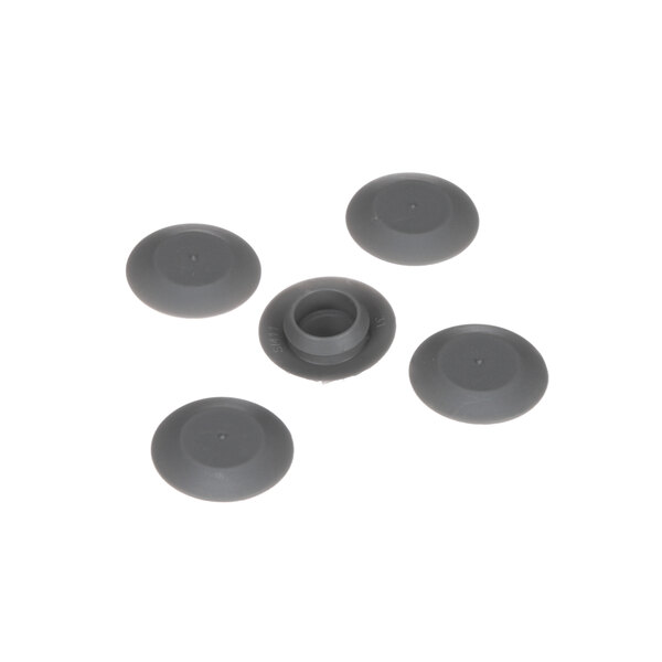A group of grey Traulsen plastic plug buttons with holes in them.