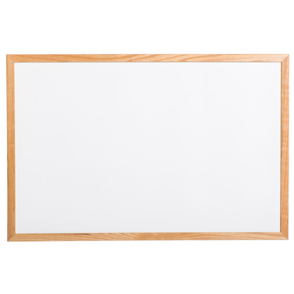 An Aarco oak frame white marker board.