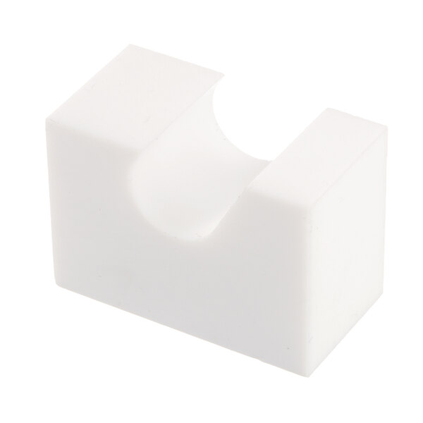 A white Teflon block with a hole in it.