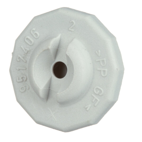 A white plastic Meiko 9517406 nozzle with a hole in it.