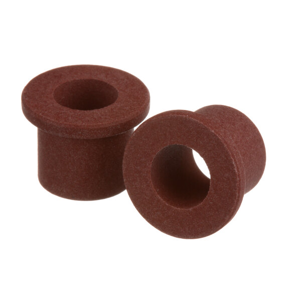 A close-up of a pair of brown rubber bushings.