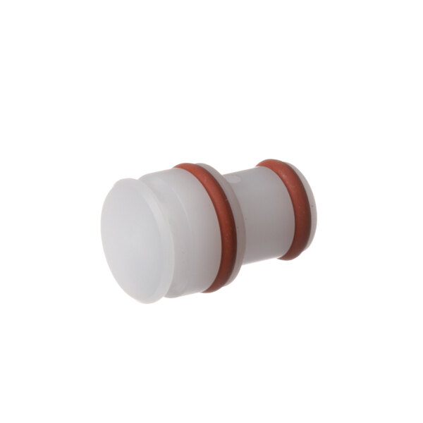 A white plastic Franke milk system nozzle with a red tube and brown and white plastic parts.