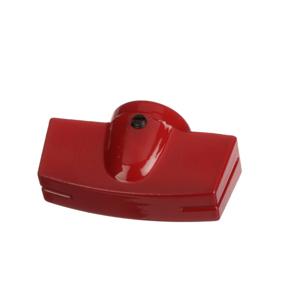 A close-up of a red plastic knob with a screw.