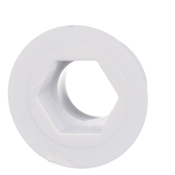 A white plastic circular Beverage-Air drain flange with a hole in it.
