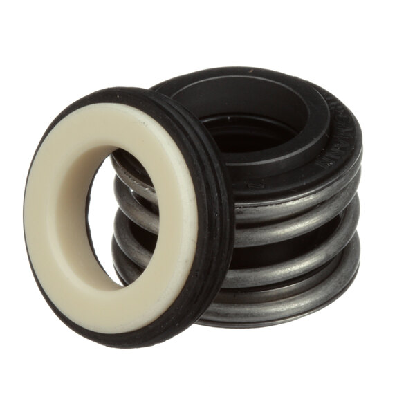 A white rubber seal with a black metal ring and a stack of metal rings.