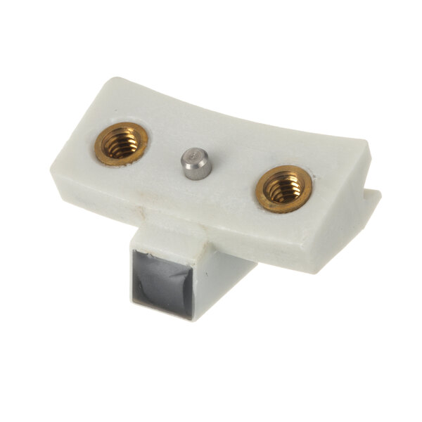 A white plastic piece with gold and silver screws.