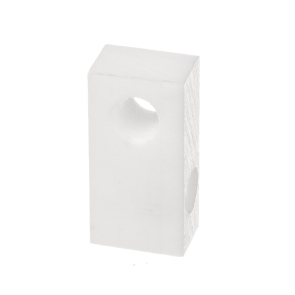 A white plastic block with a hole in it.