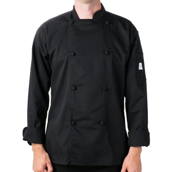 A man wearing a Mercer Culinary black long sleeve chef jacket with knot buttons.