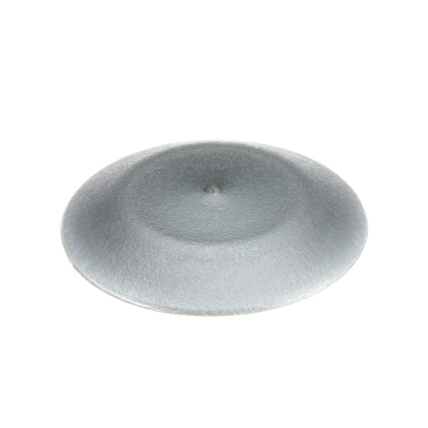 A close-up of a grey round cap plug with a hole in it.
