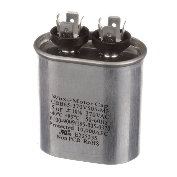A metal Blodgett 38610 capacitor with black and white text on black caps and two terminals.