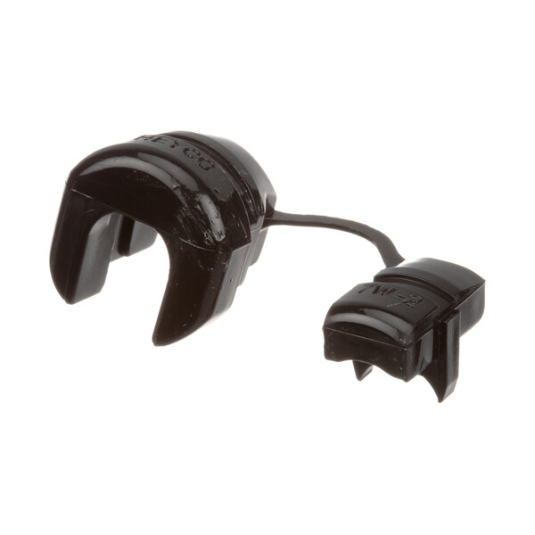 A black plastic Lockwood H-CAP socket cap for a cord hole with a wire.