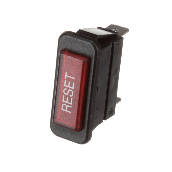 A close-up of a red and black Groen indicator light reset switch.