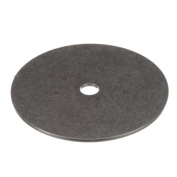 A circular metal disc with a hole in the center.