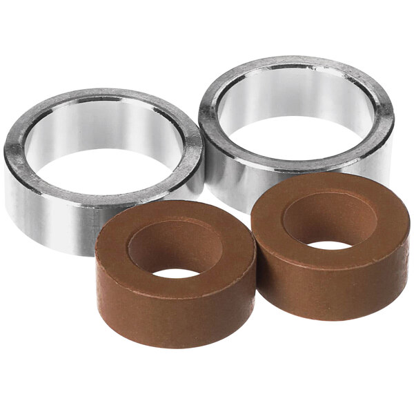 A close-up of two brown rubber bushings.