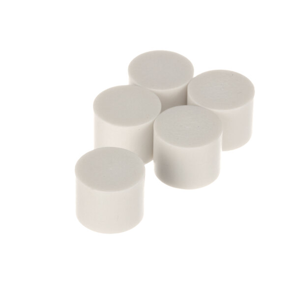 A close-up of several white cylinder caps.