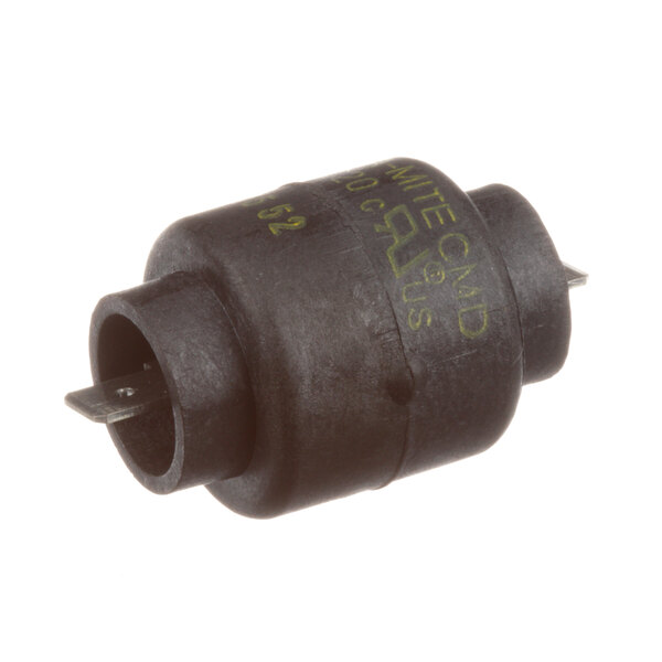 A black round electrical resistor with a small hole in the center and green writing.