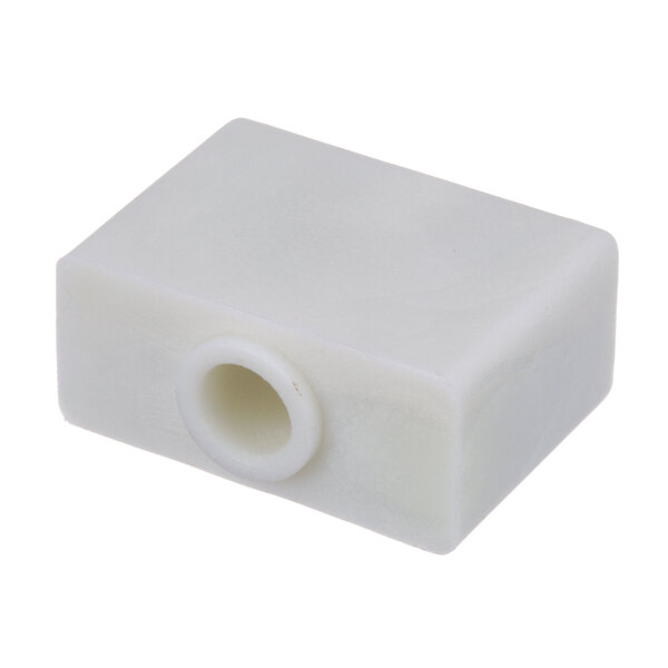 A white plastic square with a hole in the middle.