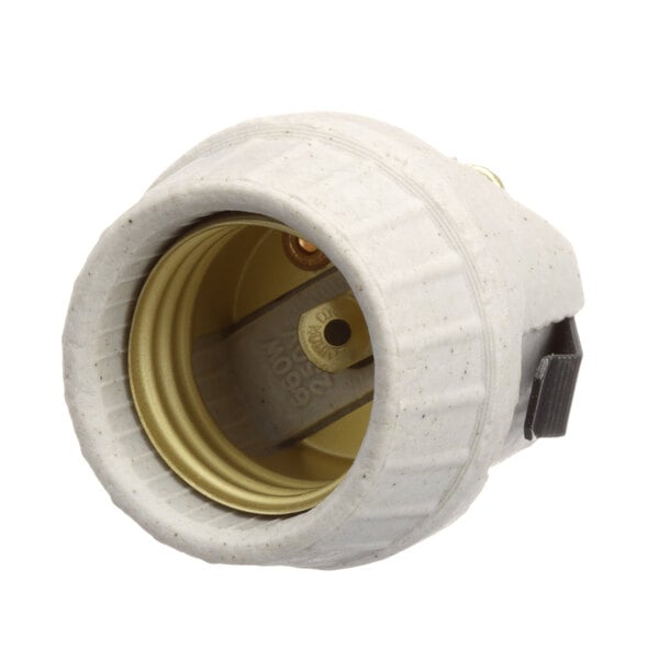 A white plastic Blodgett lamp socket with a gold metal cover.