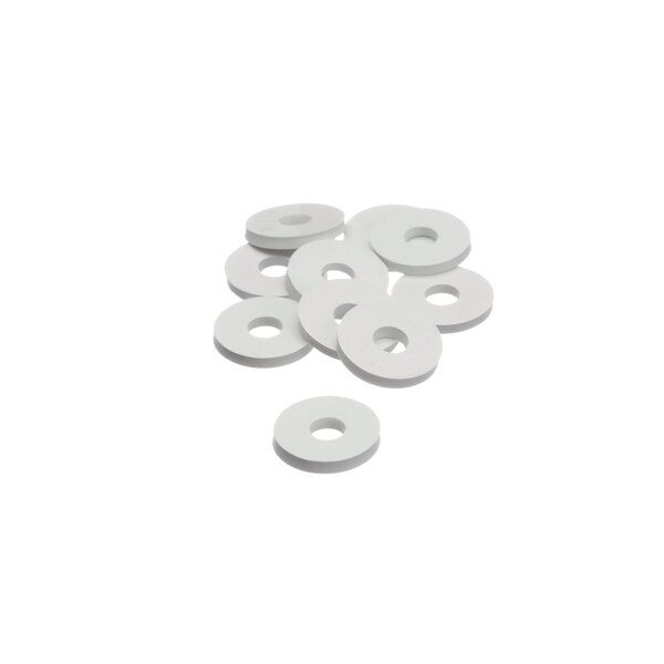 A pile of white Ice-O-Matic rubber washers on a white surface.