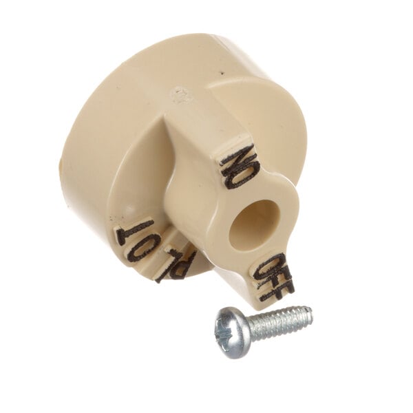 A beige plastic gas valve knob with a screw.