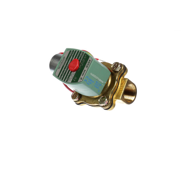 A close-up of a Groen brass valve with a red button.