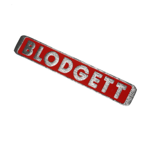 A red, silver, and white metal Blodgett name plate.