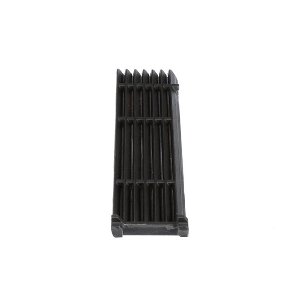 A black cast iron Garland broiler grate with spikes.