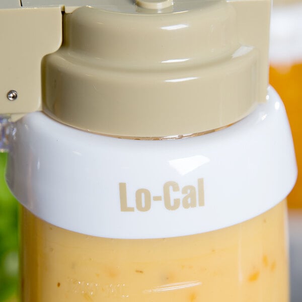 A Tablecraft plastic container with a white lid and beige lettering containing a liquid.