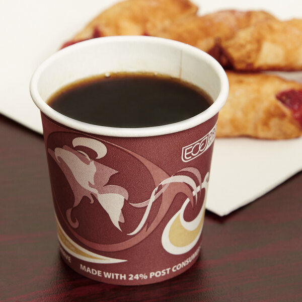 An Eco-Products Evolution World paper hot cup of coffee on a table with pastries.