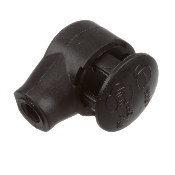A close-up of a black plastic cap with a hole in it.