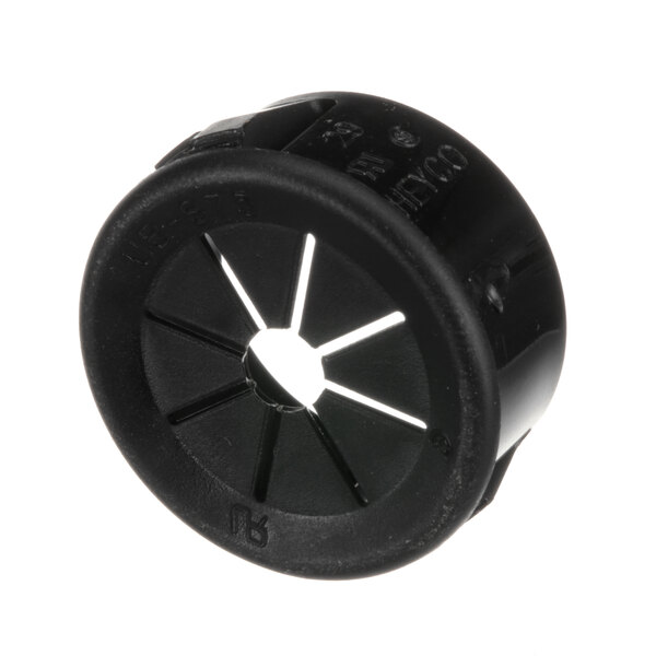 A black circular plastic bushing with holes on top.