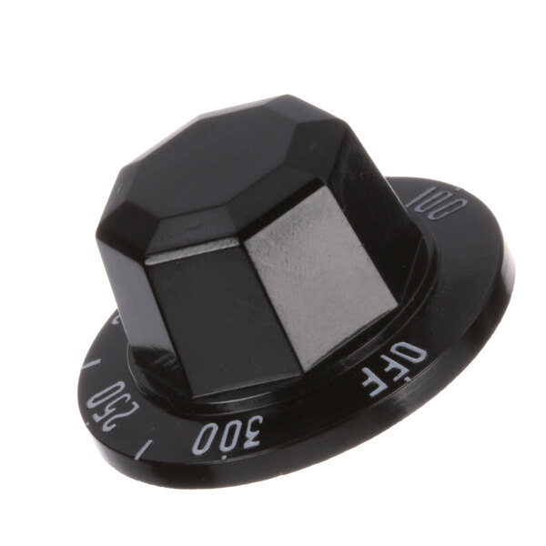 A close-up of a black plastic Groen knob with white text that says "0"