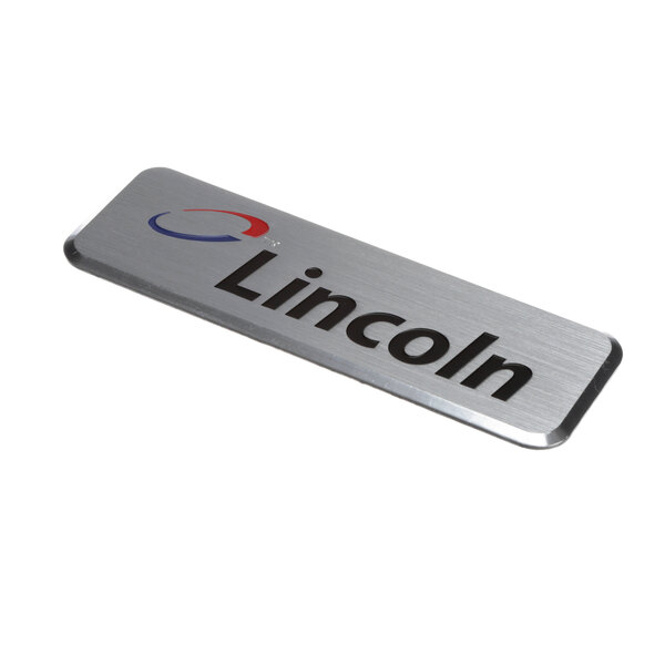 A close-up of a Lincoln logo on a metal plate.
