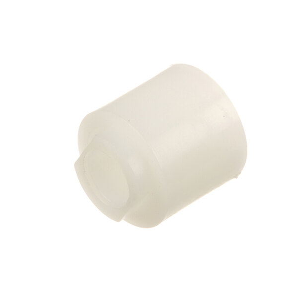 A white plastic object with a small hole.