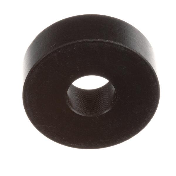 A black circular object with a hole.