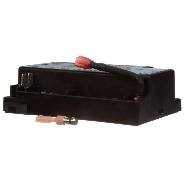 A black US Range ignition module with red and black connectors.