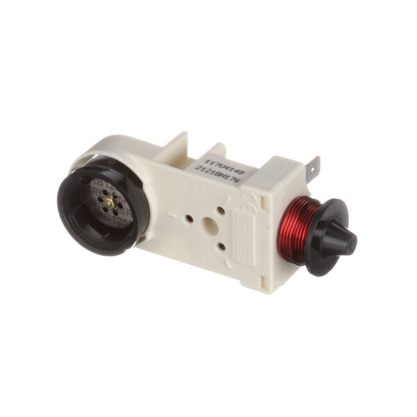 A white and black plastic Franke relay/overload device with red wires.