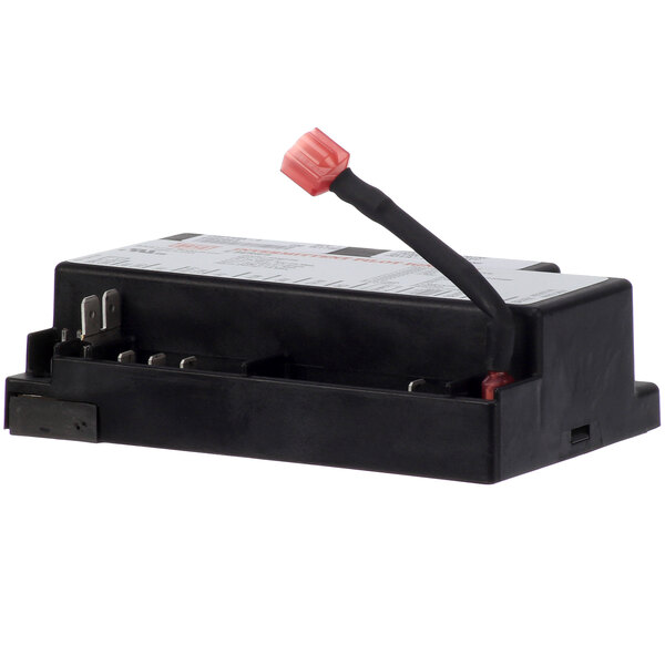 A black rectangular ignition module service kit with a white label and a red cap.